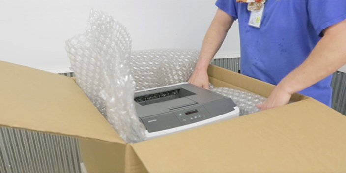 Laser printer in box with bubble wrap on sides